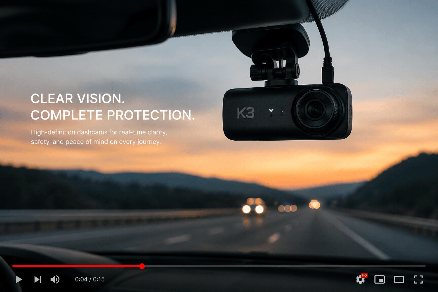 Dashcam mounted on a windshield capturing the road at sunset